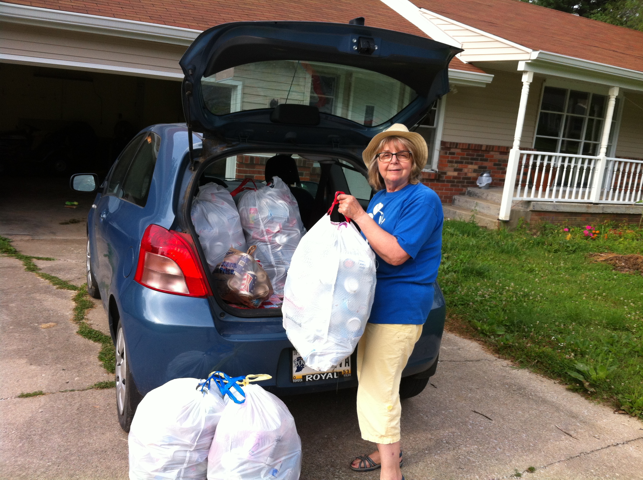 Georgia collects Rebekka's bags to add to her own for the Uncanny Project's first trip to recycling center, July 12, 2014. Mark the day!